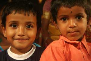 Most women and children watch Kambala from a safe distance.