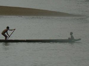 Nuqui, Colombia, on the Rarely Visited Pacific Coast 4 Boys in a dugout canoe, the preferred method of transport on the Pacific coast of Colombia.