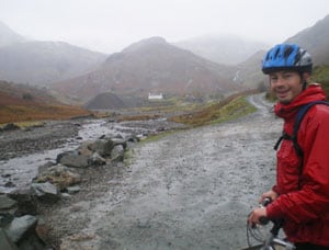 Johan Hoving in front of Coniston's former copper mill, atop a hill we climbed on mountain bikes. He said some US guests are weather wimps. Not us!