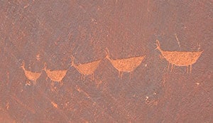 These ancient petroglyphs were carved right into the red sandstone.