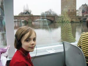 Listening to the children's audio guide on a boat ride of the Ill river.