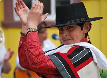 A little boy takes pride in dancing the Cueca.