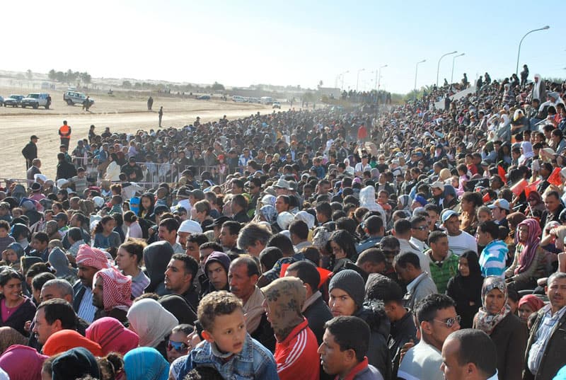The Festival of the Sahara in Tunisia 2 Spectators wait patiently in the blazing sun for the dignitaries to arrive.