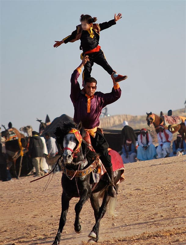 The Festival of the Sahara in Tunisia 5 A galloping horse carries a brave father-son team.