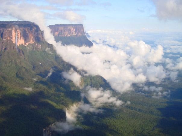Roraima and Kukenaam rise above the rainforests of Guyana at the triple border with Brazil and Venezuela. Photo by David Joshua Jennings.