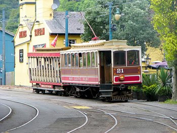 A train on the Manx Electric Railway clanks into the station at Laxey.
