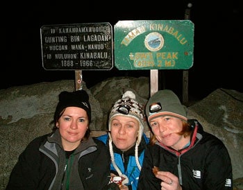 At the summit, Michelle (far right) munches on chocolate as a reward for reaching Low's Peak.