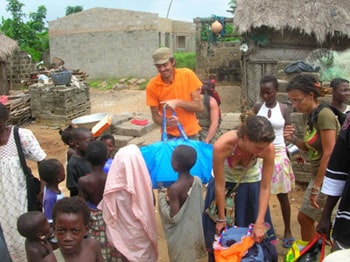 Brandon McKay and Stefny Poillot giving out clothes to the people of Asaafa, Ghana