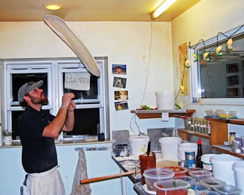 Putting on a show with some dough. Corey Walsh at the Trout River Brewing Company on Broad Street in Lyndonville, Vermont.