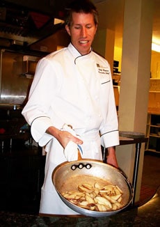 Chef Andy Blanton of Cafe Kandahar gives a private demonstration of how he sautees slices of pear for his pear-ginger-white chocolate tart. Photo by Kelly Westhoff.