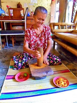 A Jamu preparing ingredients at her house