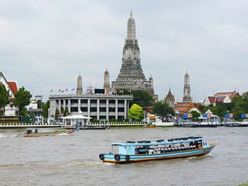One Day in Bangkok for Less Than Ten Dollars (US) 9 A river taxi plies the Chao Phraya River in front of Wat Arun.