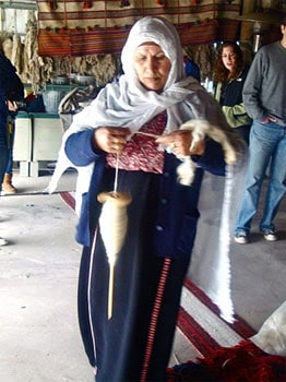 Giving Back to Israel 7 Woman of the Laquiya Weaving Project, working on a rug