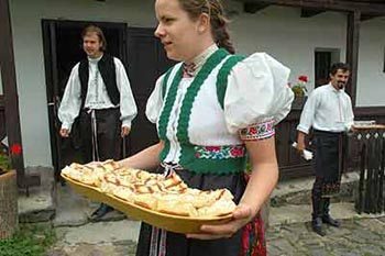 Enjoying some local hospitality: cakes and pear brandy in Holloko, Hungary.