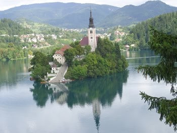 Slovenia: Communist Hangover, Cured 3 SloveniaÂ’s Church of St. Mary in the midst of Bled Lake is the proverbial island unto itself. Visitors are encouraged to ring the church bells while making a wish.