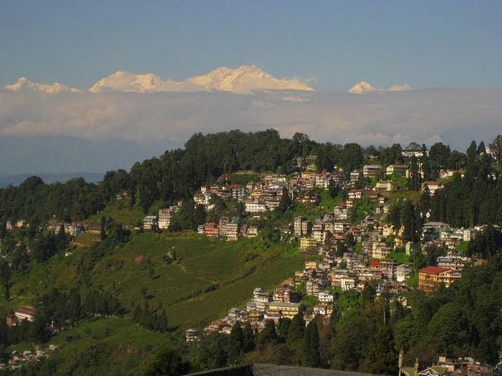 Darjeeling, overshadowed by the massive Himalayan Mountains behind it.