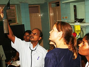 Volunteers and doctor examine x-rays in India.