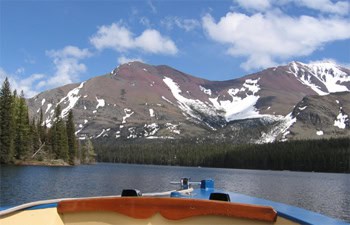 Red buses in Glacier National Park. You can take a scenic tour in a boat of Two Medicine and other lakes in Glacier National Park.
