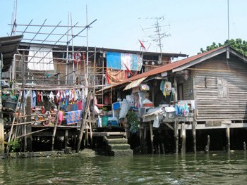 Laundry flaps in the wind at this shack on the canal in Bangkok.