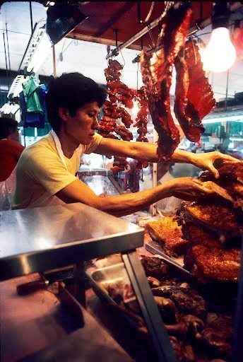 Meat cutter in the Honolulu Chinese Market. Meat cutter in the Honolulu Chinese Market.