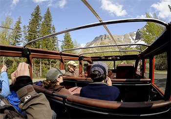 Red buses at Glacier National Park. With the top down, the bus provides an even more spectacular view of this gorgeous park. photo by Donnie Sexton.