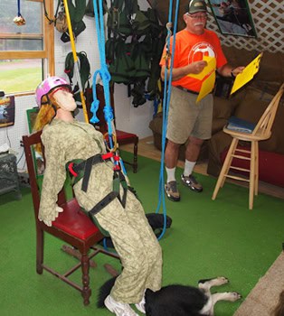 Allan goes through safety procedures using a dummy all roped up.