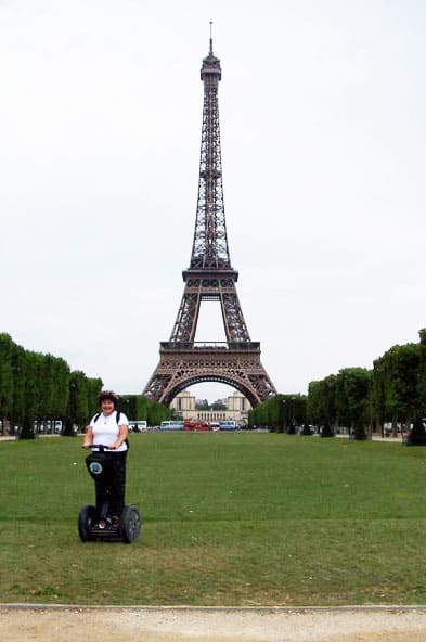The author poses in fron of the Eiffel Tower on her Segway.