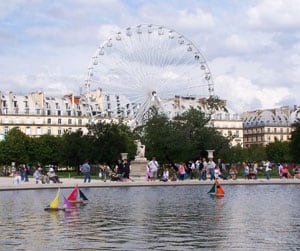Tuileries fountain with ferris wheel and Louvre in background