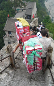 A porter hauls a heavy load.