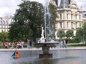 Tuileries fountain in front of the Louvre with children's sailboat