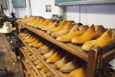 Shoe lasts on display with textile manufacturing machinery at the L-A Museum, Lewiston.