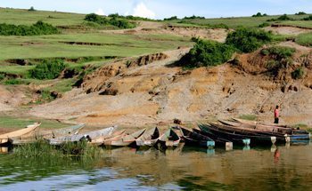 Wooden canoes are shored up in a village along the Kazinga Channel in Queen Elizabeth National Park. Tribes who lived in the area before the park's boundaries were drawn are allowed to continue living inside the park.