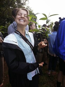 Christina Justice helps plant a tree.