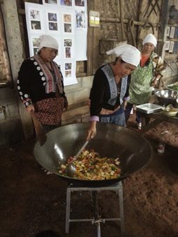 Hmong women preparing a big stir fry for lunch.