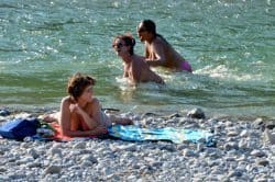 Nude bathers by the river in Munich.