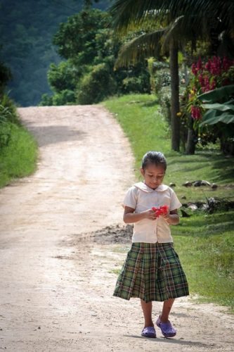 A girl on the road to school in San Antonio Belize.