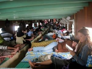 Borneo's Smoking Skulls and Sacrificial Swine 4 S Bedford aboard the longboat on the way to the longhouse in Borneo.