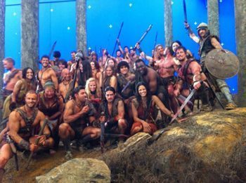 Male and female actors pose on the set of Spartacus.