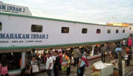 Boarding the longboat in Balikpapan, Borneo.