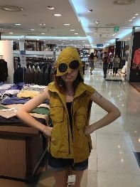 Trying on a unique piece of designer clothing at a large mall in Daegu