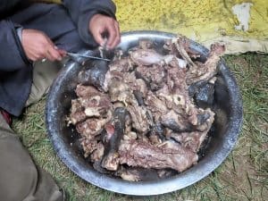 Goat dinner with fat and bones still attached.