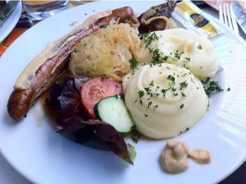 Local lunch of wurst and potatoes goes great with local beer.