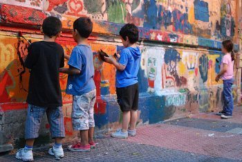 Kids painting a mural.