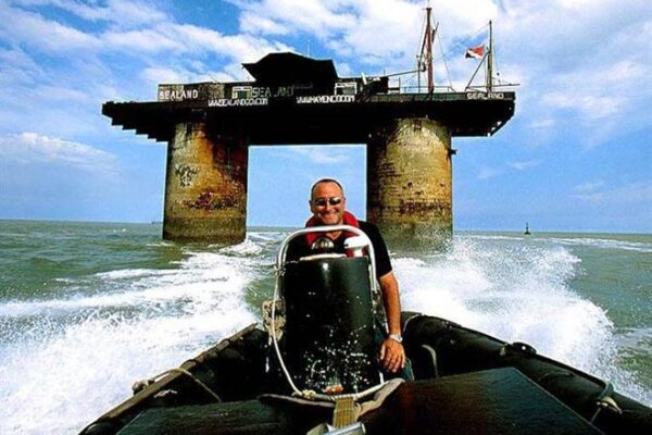 Prince Michael rides his boat with Sealand in the background. Photos from www.sealandgov.org