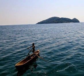 A curious Moken child glides toward us in a traditional kabang boat, so swiftly his rowing seems effortless. Breawna Power Eaton photos.