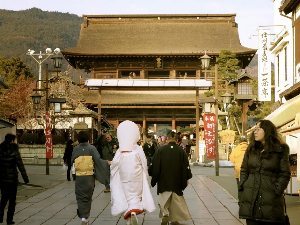 Nagano, Japan: A rare glimpse of a bride in a traditional gown, on her way to Zenkoji Temple.