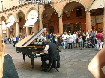 A street performer on Sundays when cars are blocked off.