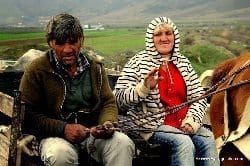 Locals on a horsecars in Albania.