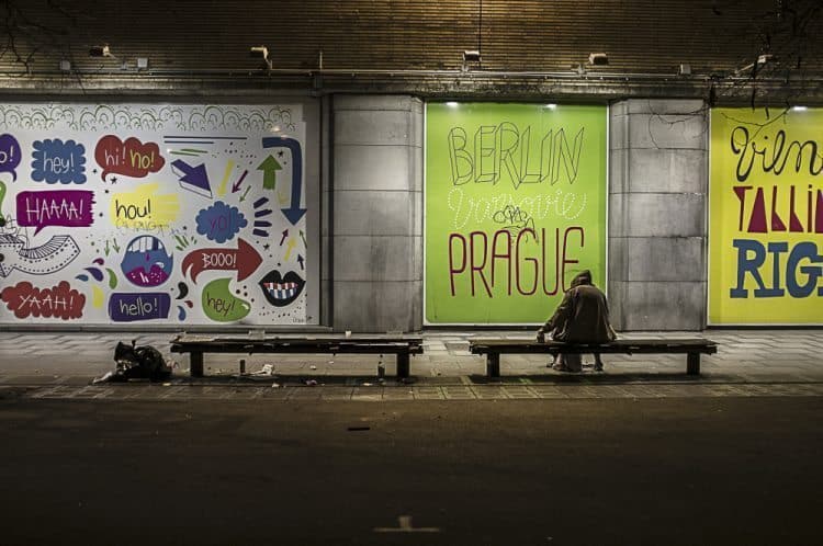 A man sits on a bench in Brussels, Belgium.