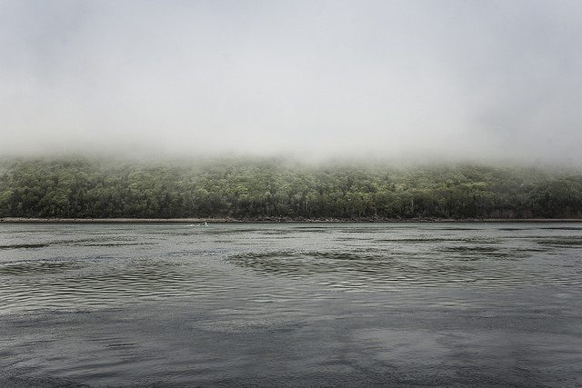 A fishingboat pulls traps in the distance, on the ferry ride home. 